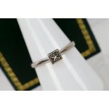 A 9ct white gold diamond solitaire ring, set with a 10 point stone, size O+½, approximately 2 grams.