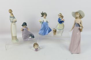 A group of Lladro and Nao figures to include # 4505, Girl With Lamb and other,