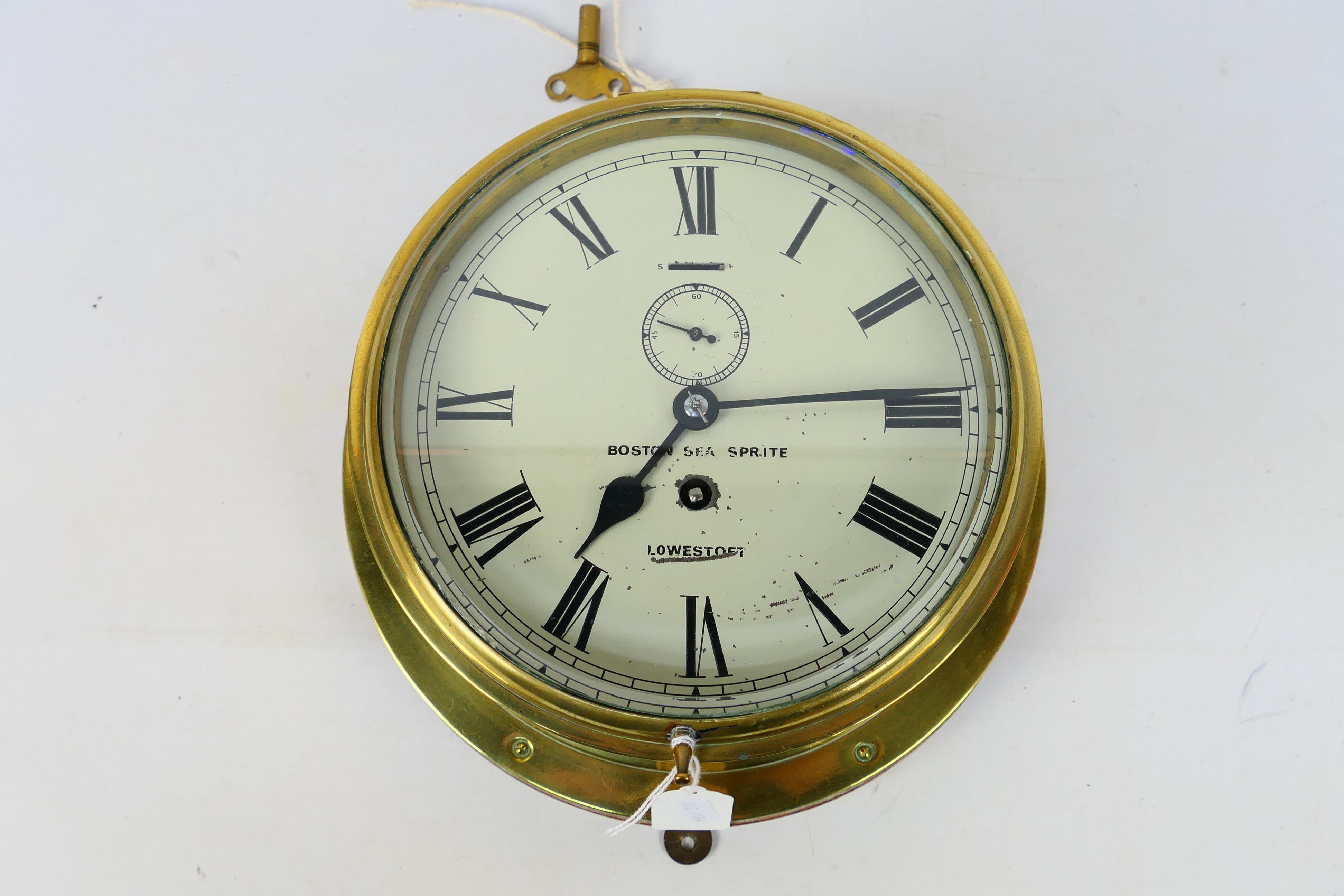 A brass-cased ships bulkhead clock,