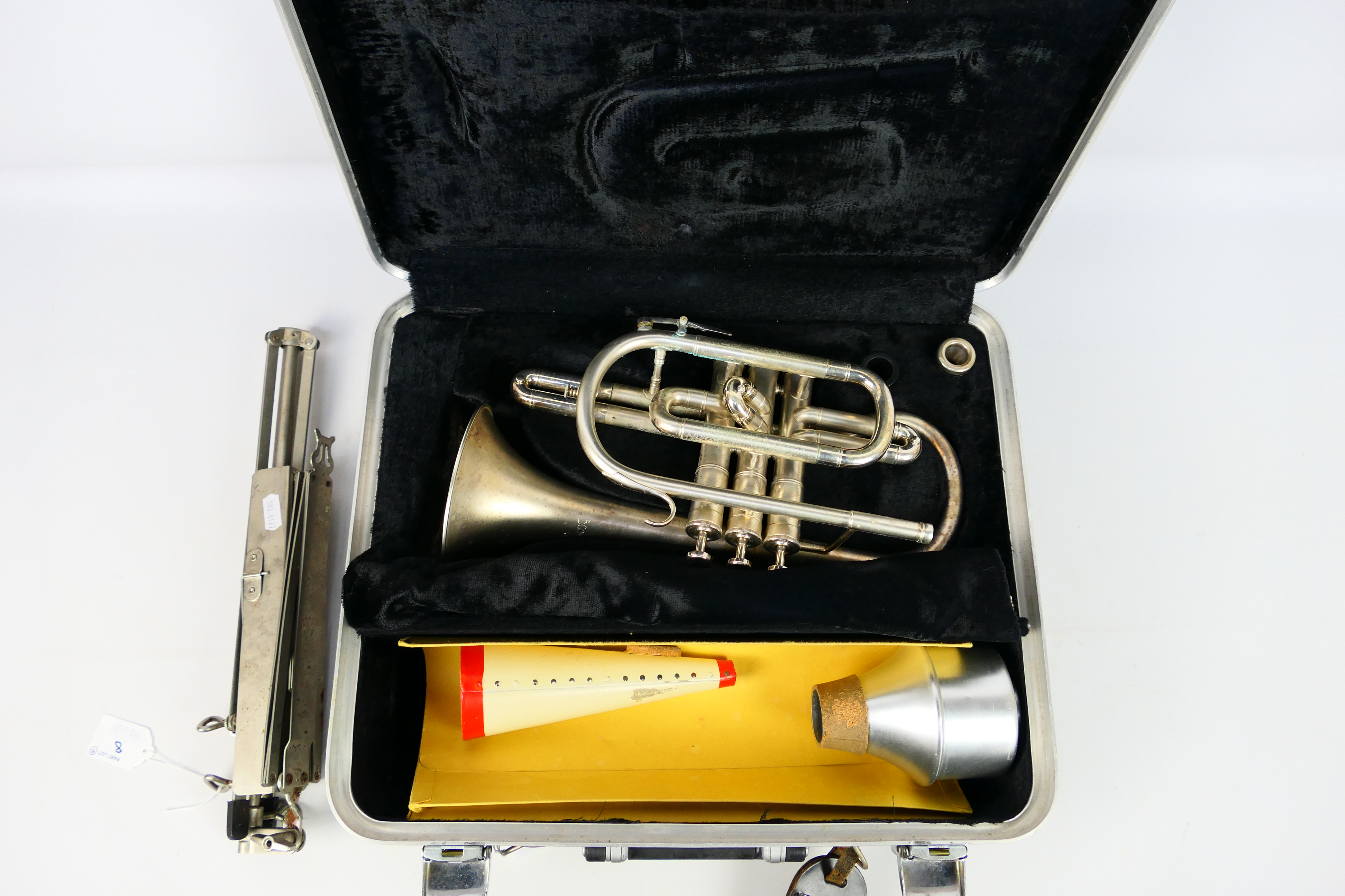 A Boosey & Hawkes Regent cornet numbered 672823, contained in hard case and with music stand. [2].