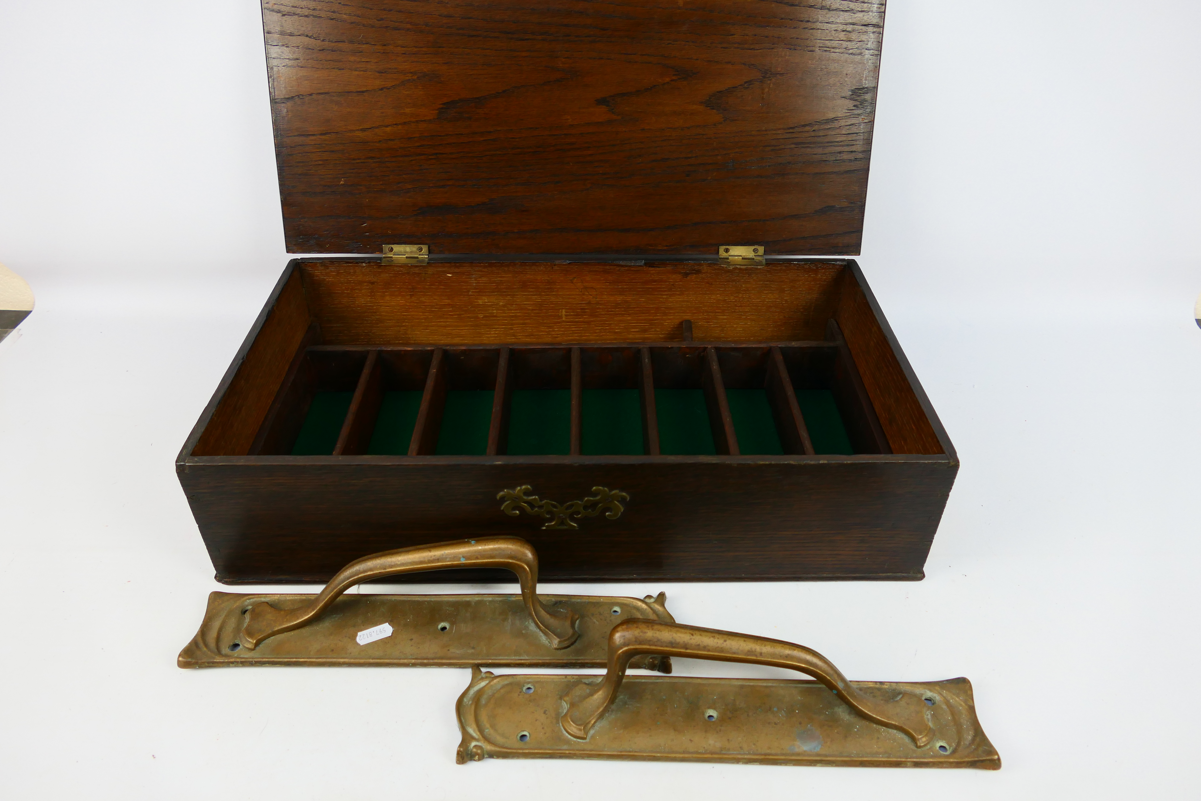 A vintage cutlery box and two Art Nouveau style brass door handles.