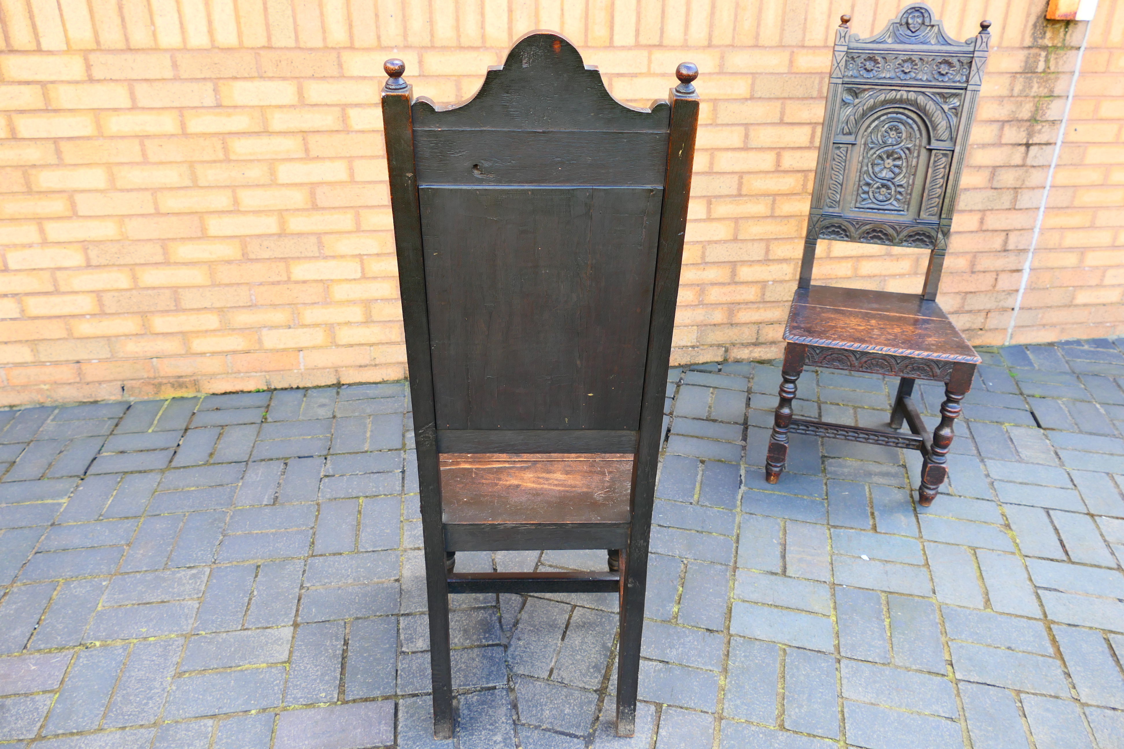 An antique pair of highly carved oak hall chairs. [2]. - Image 6 of 6