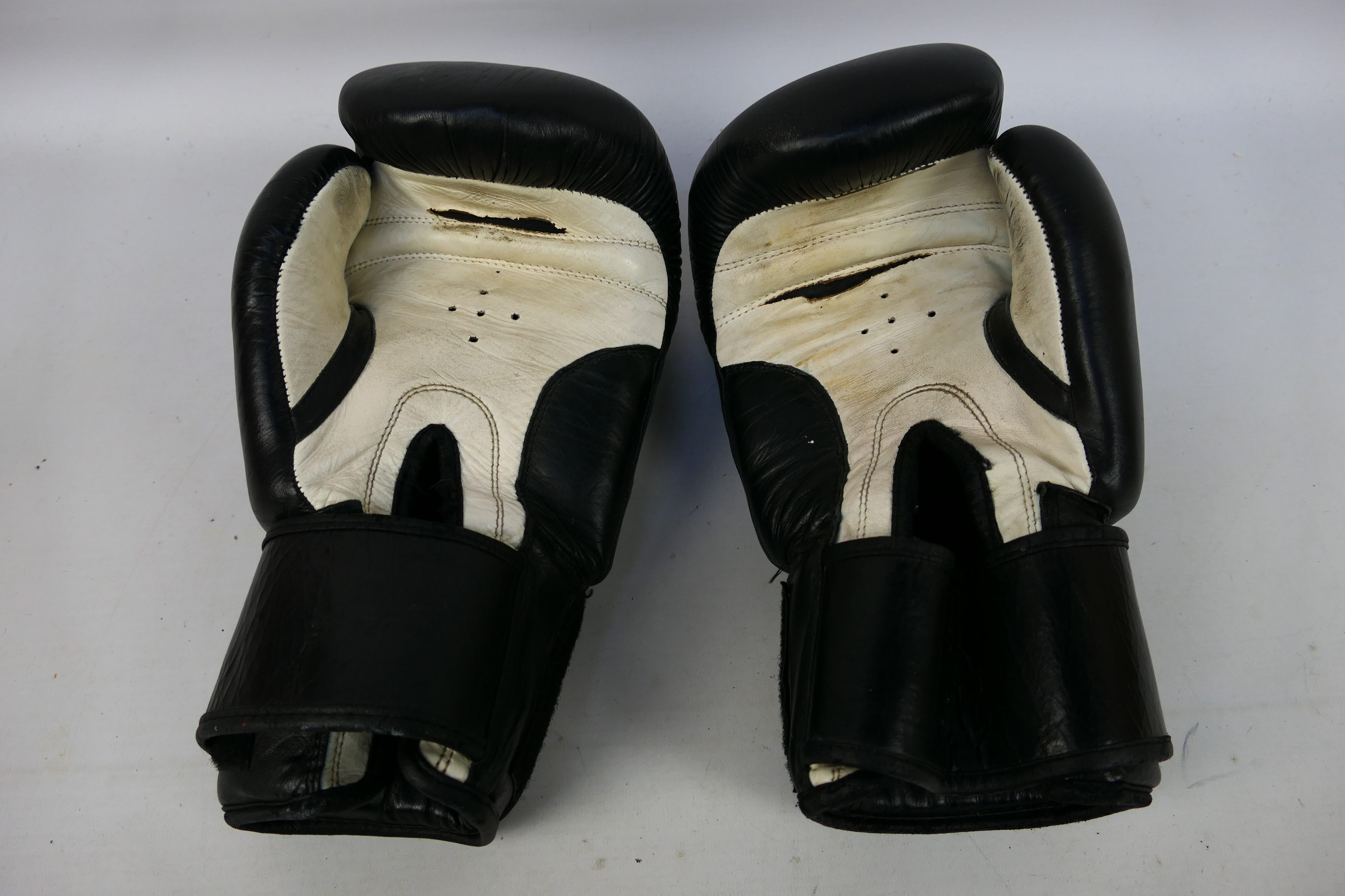 A pair of 16 oz Geezers Palace boxing gloves in black and white. - Image 2 of 2