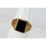 A 9ct yellow gold and onyx signet ring, size R, 3.1 grams.