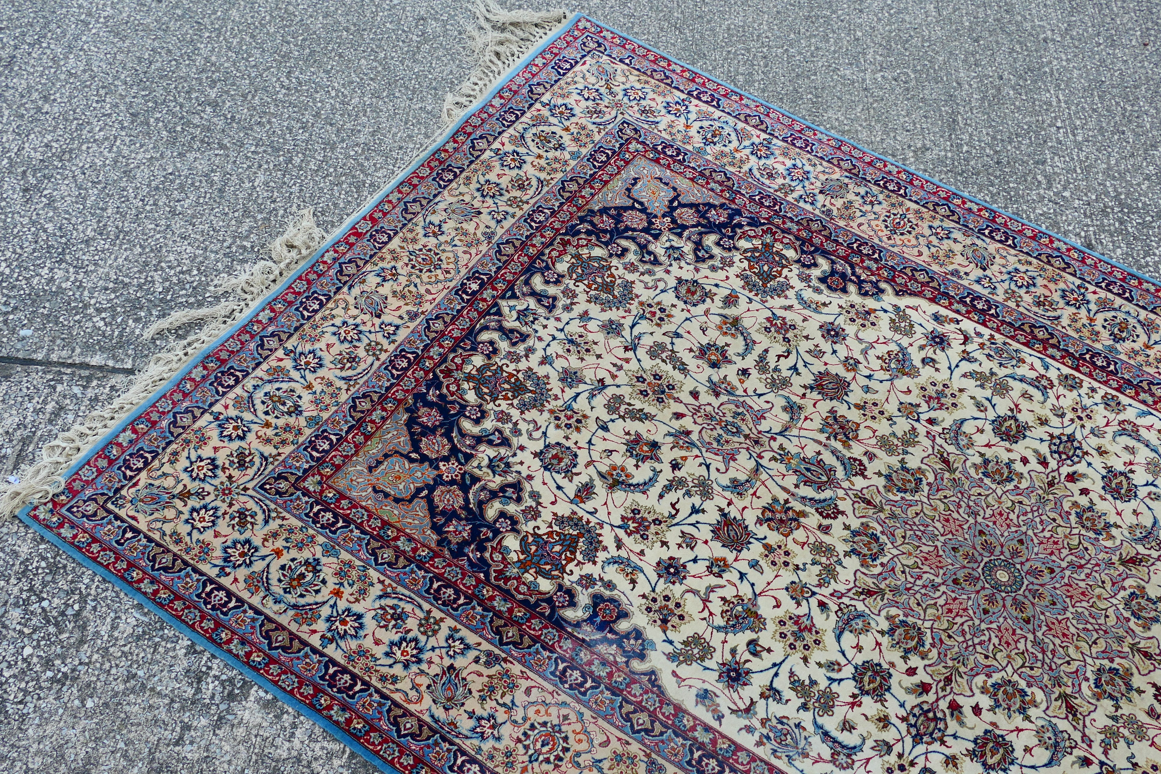 A signed Persian ivory ground rug with central floral medallion, - Image 2 of 7