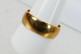 A 9ct yellow gold band ring, 7mm (w), size V, approximately 4.9 grams.