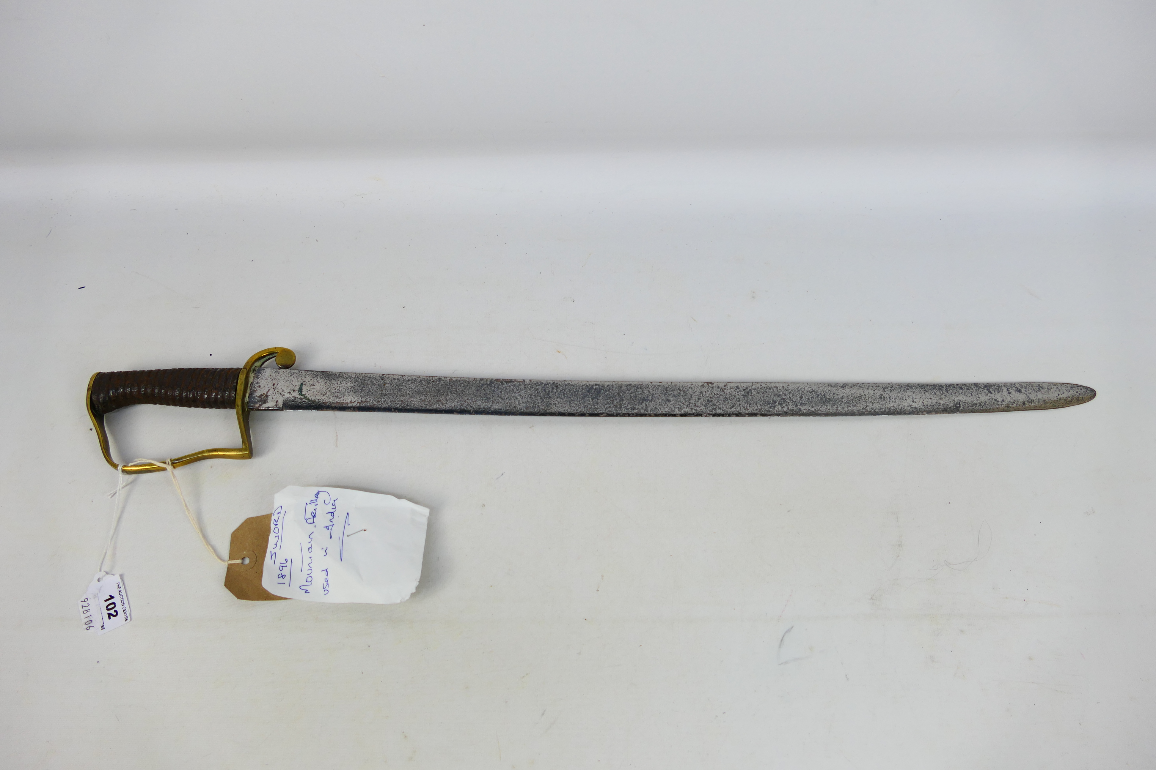 An 1896 pattern Mountain Artillery Sabre style sword, brass stirrup hilt and ribbed iron grip. - Image 2 of 7