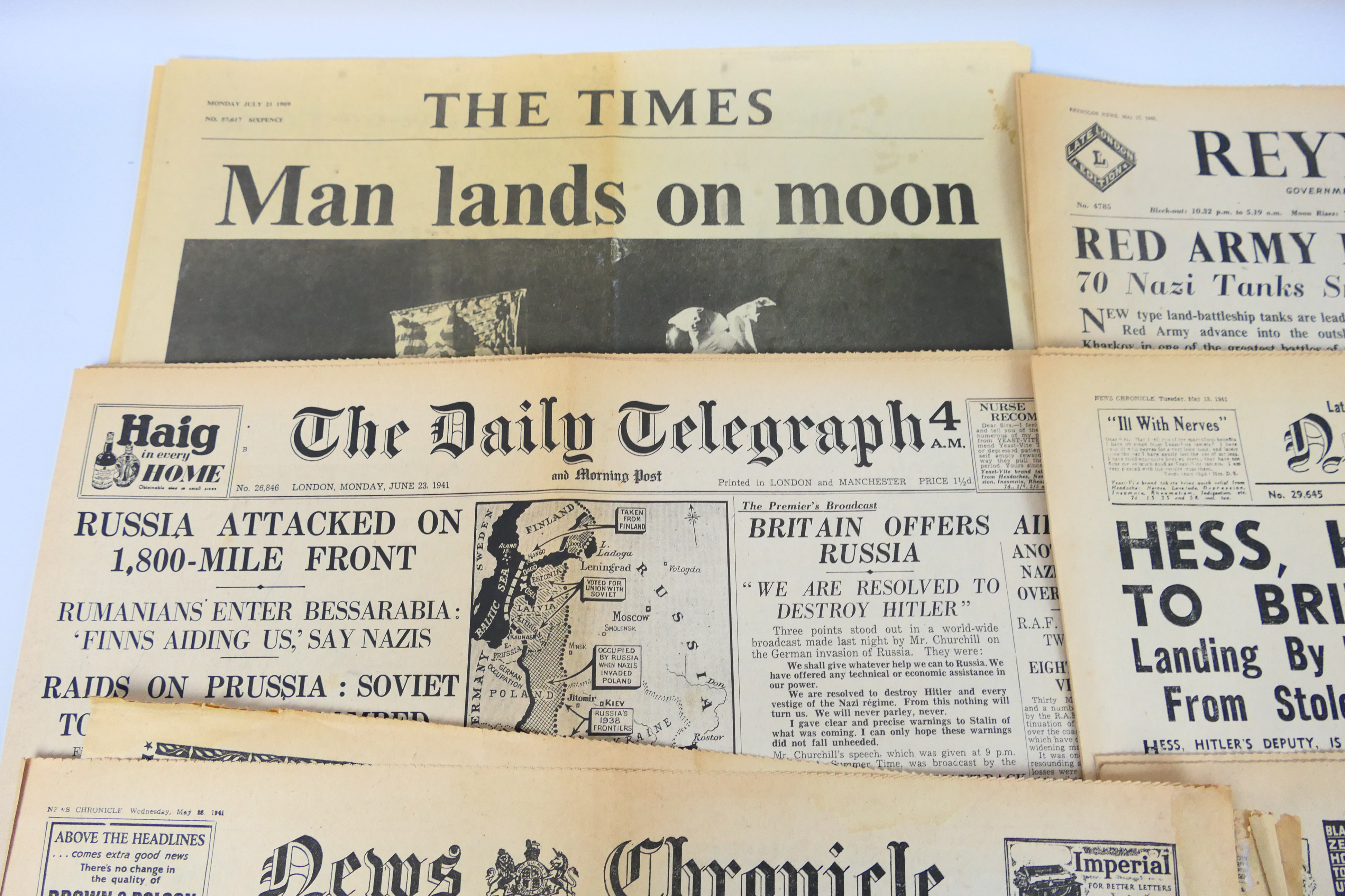 A collection of vintage newspapers with front pages detailing historically significant events to - Image 2 of 6