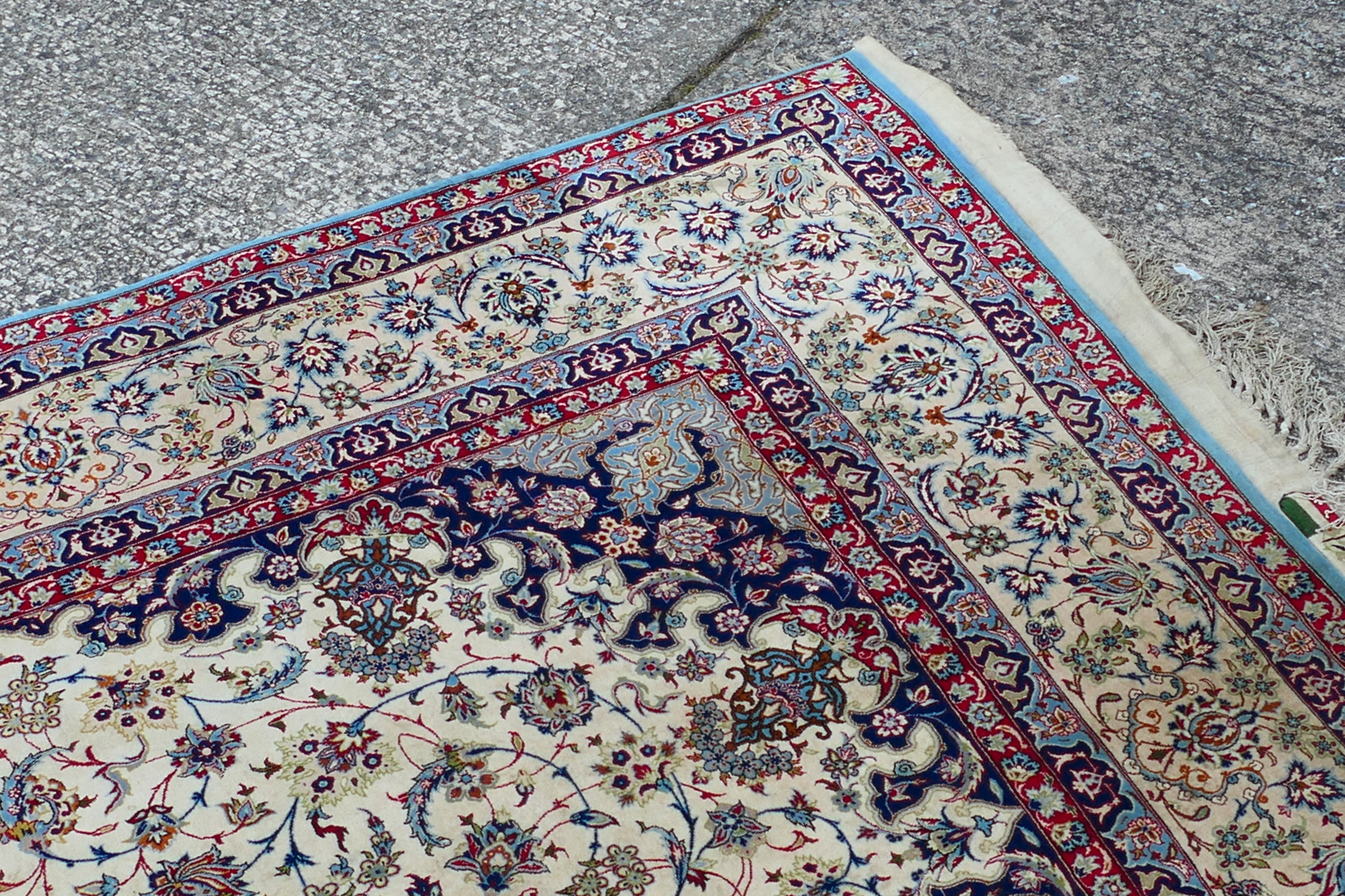 A signed Persian ivory ground rug with central floral medallion, - Image 5 of 7
