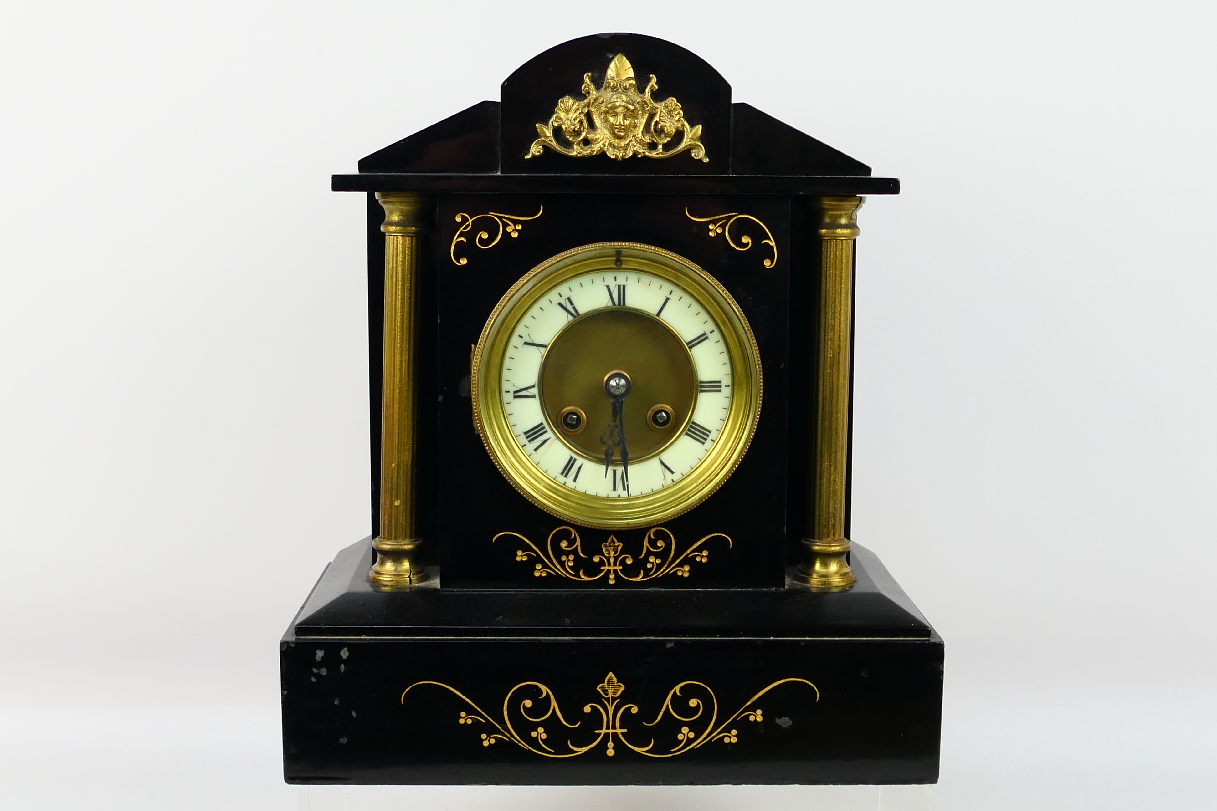 A 19th century black slate mantel clock of architectural form,