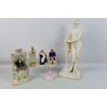 A collection of Staffordshire and other to include a Wesley clock and a large plaster figure,