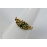 A vintage 9ct yellow gold ring set with emerald and pearl, size O+½, approximately 2 grams.