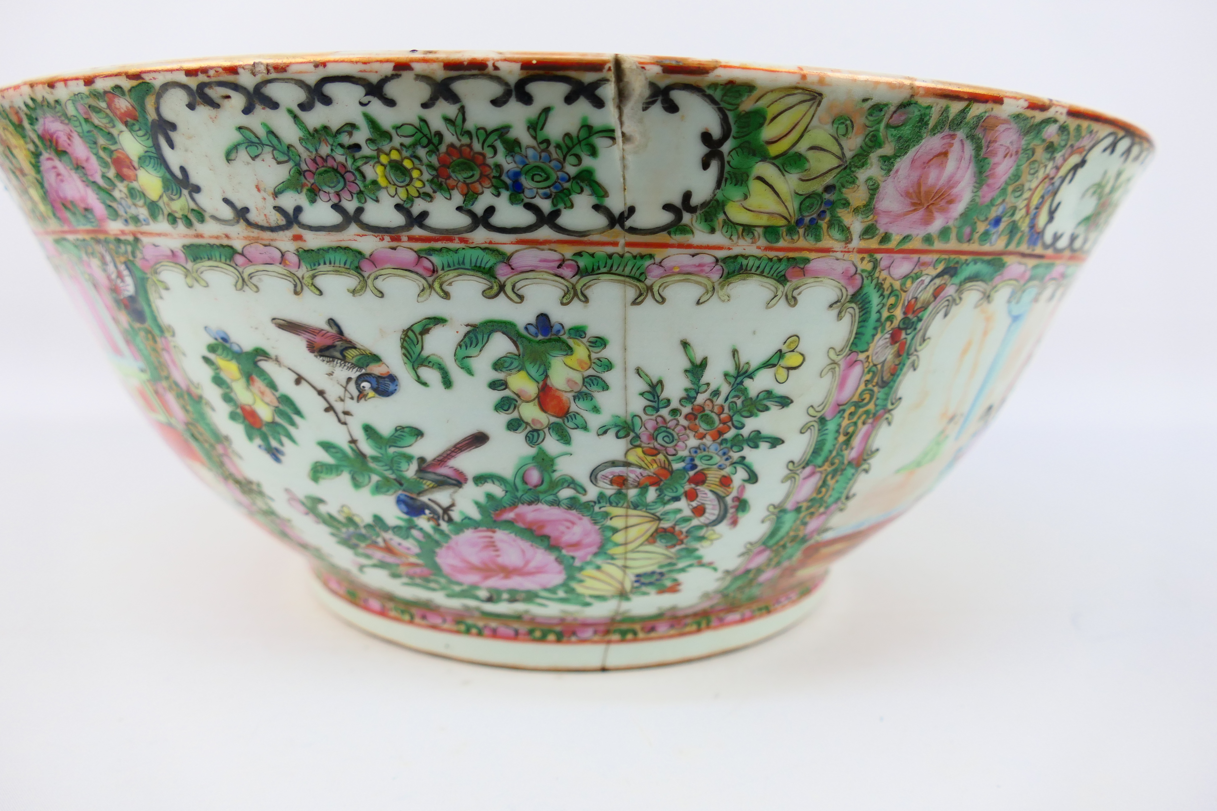 A large Cantonese famille rose punch bowl, typically decorated with panels of figures and flora, - Image 8 of 9