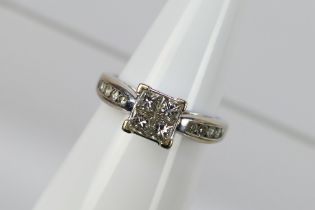 A diamond ring set in white metal stampe