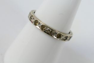 A white metal, diamond set eternity ring