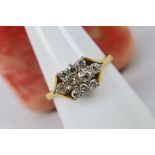 A gold and diamond cluster ring centrall