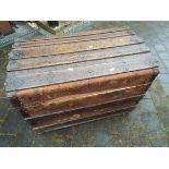 A late 19th/early 20thC domed top trunk with wooden slats,