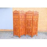 A four fold screen / room divider with pierced and carved decoration of fruiting vine and foliate