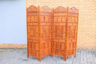 A four fold screen / room divider with pierced and carved decoration of fruiting vine and foliate