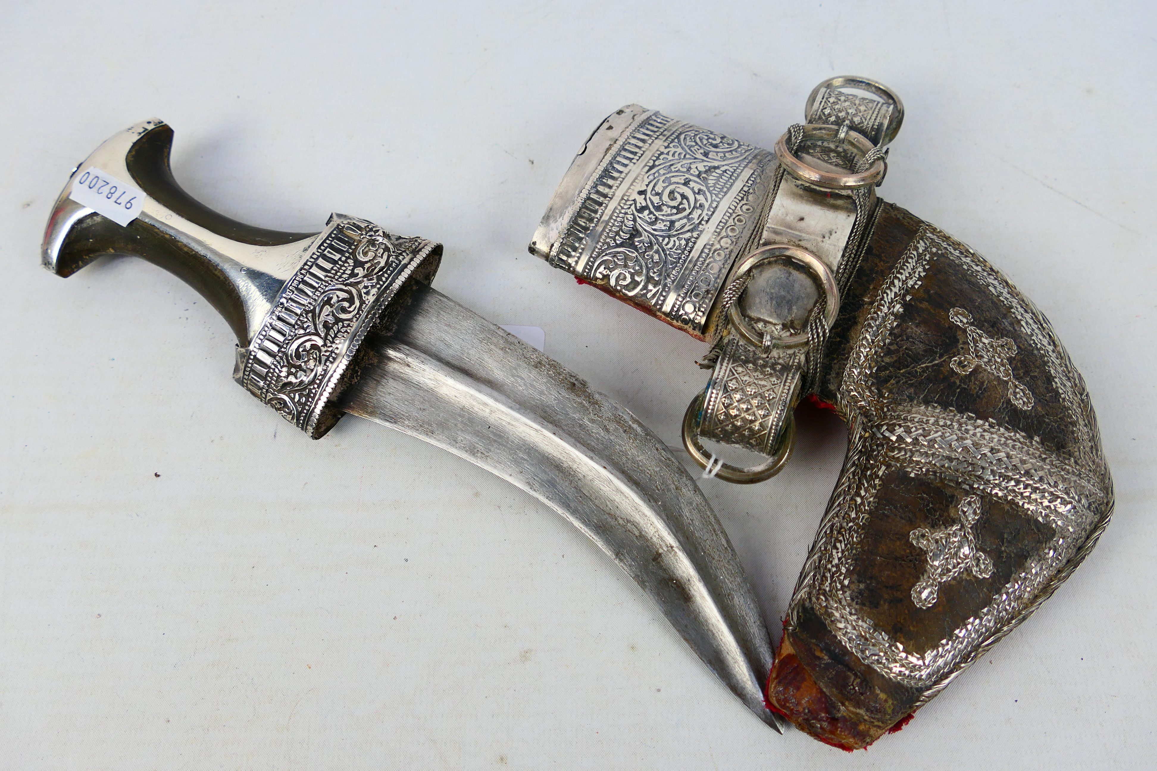 An early 20th century white metal mounted jambiya dagger and scabbard,