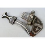 An early 20th century white metal mounted jambiya dagger and scabbard,