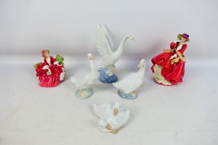 Four Nao bird studies and two Royal Doulton lady figures, largest approximately 21 cm (h).