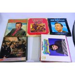 A collection of 12" vinyl records to include Jim Reeves, Elvis Presley Greatest Hits, Abba,