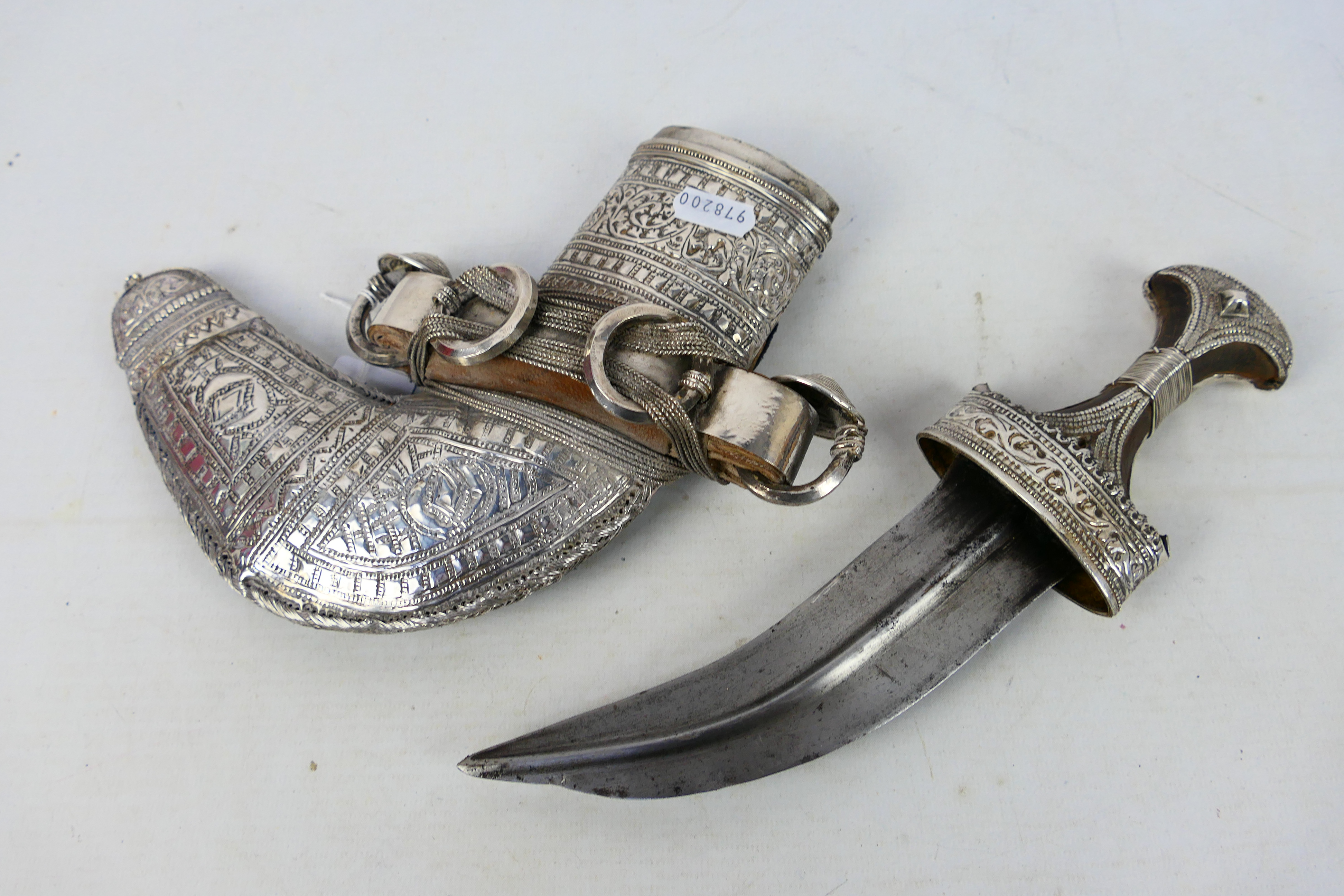 An early 20th century white metal mounted jambiya dagger and scabbard,