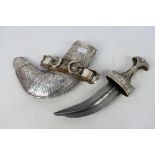 An early 20th century white metal mounted jambiya dagger and scabbard,