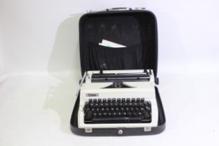 Erika - GDR - An Erika #105 typewriter in carry case. Carry case appears broken.