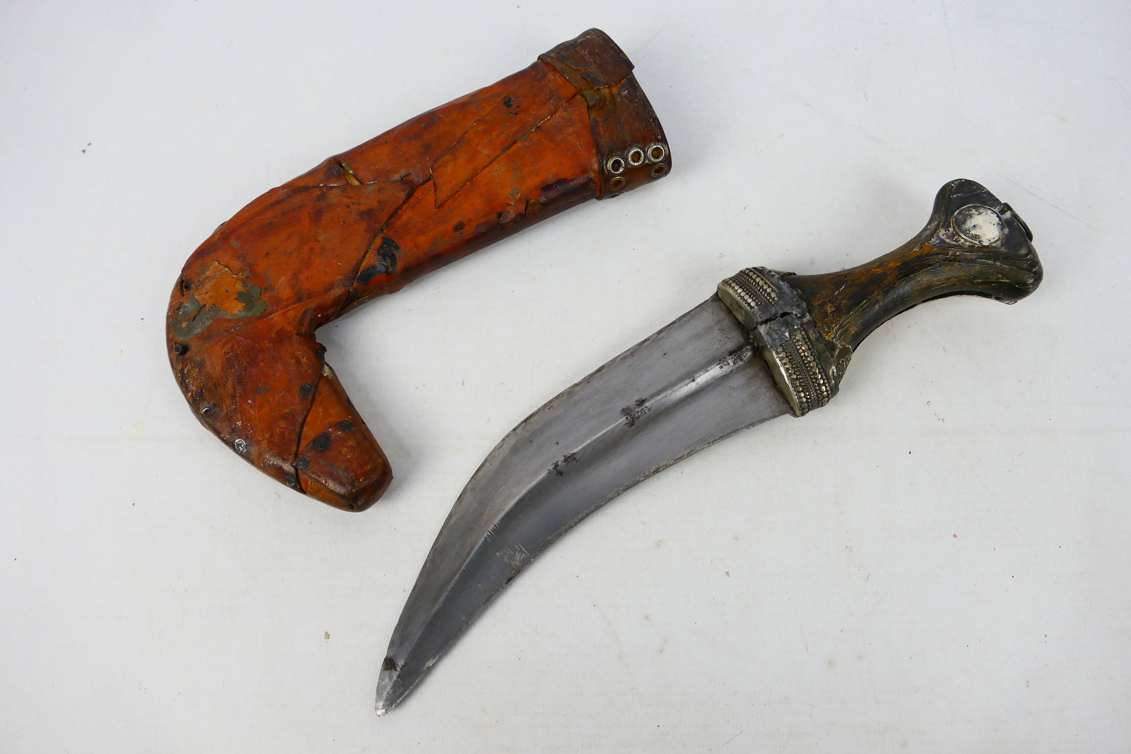 A late 19th or early 20th century white metal mounted jambiya dagger,