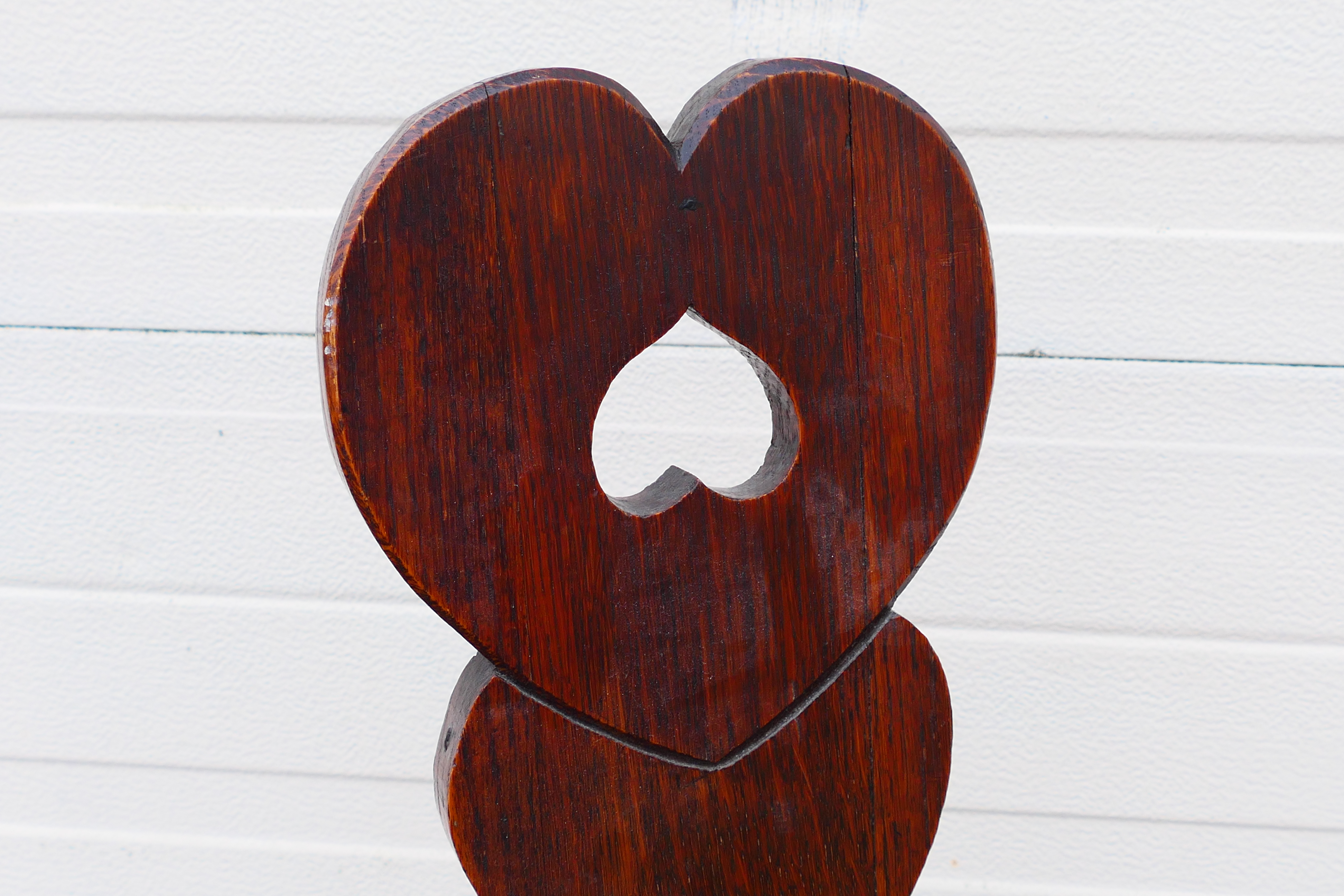 A wooden spinning chair with heart-shaped design. 120 cm (h) x 31 cm (d) x 35 1/2 cm (w). - Image 4 of 6