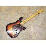 A Stratocaster shaped electric Guitar marked Fender with maple neck,