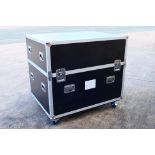 A large professional flight case raised on castors, measuring approximately 117 cm x 126 cm x 98.