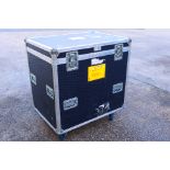 A professional flight case, raised on castors, approximately 101 cm x 94 cm x 68 cm.