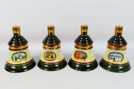 Bells - Four Wade decanters, with conten