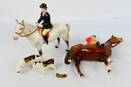 Four Beswick hunting figures comprising huntsman on brown horse and huntswoman on grey,