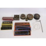 Various projector parts to include film reels, a quantity of glass slides, and similar.