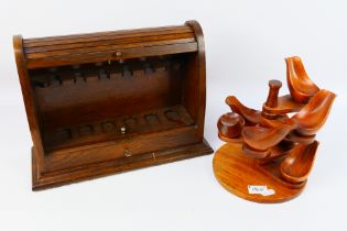 A tambour front lockable pipe rack, 27 cm x 36 cm x 13 cm and one further pipe stand. [2].