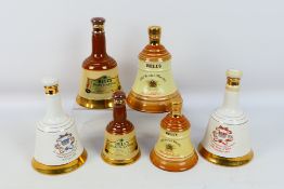 Bells - Six Wade decanters, with content