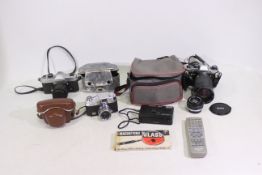 4 x cameras to include an Olympus OM 10 with spare lens and lens cover, and camera bag.