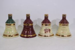 Bells - Four Wade decanters, with conten
