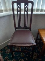 Four dining chairs with decorative pierced backs (only one chair shown in images).