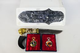 A decorative display knife with lion head pommel and two modern pocket watches.