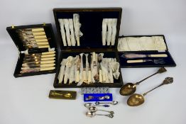 A collection of flatware, predominantly cased, including a small quantity of silver.