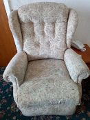 An upholstered riser / recliner armchair.