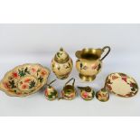 A brass Indian set with floral decoratio