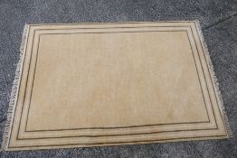A New Zealand wool rug of gold tone, approximately 232 cm x 160 cm.