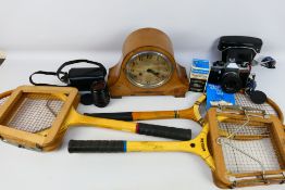 A mixed lot to include a wooden mantle clock with pendulum and key. 3 x vintage tennis rackets.