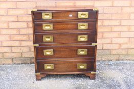 A contemporary campaign style chest of five graduated drawers by Bevan Funnell Ltd,